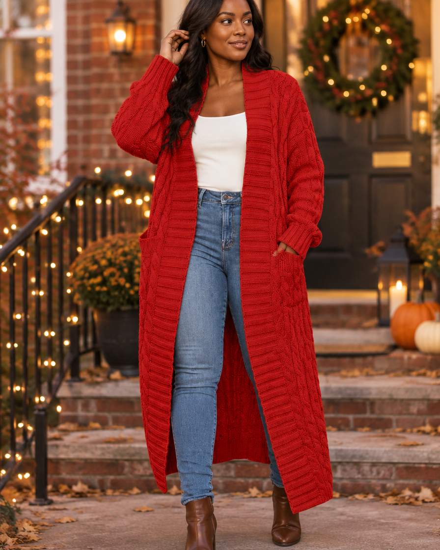 Red cable-knit maxi cardigan worn on a townhouse porch in late autumn