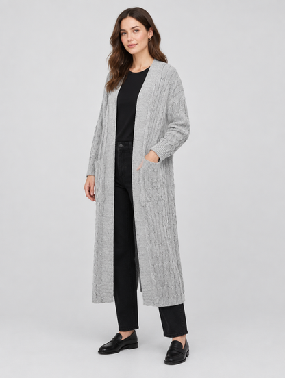 Woman wearing the Maren grey cable-knit maxi cardigan over a black tee and black jeans
