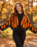 Monarch wing knit cardigan in Orange, worn in an autumn park